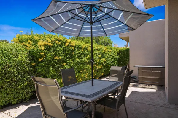 a patio with a table and chairs