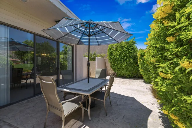 a patio with a yard table and chairs