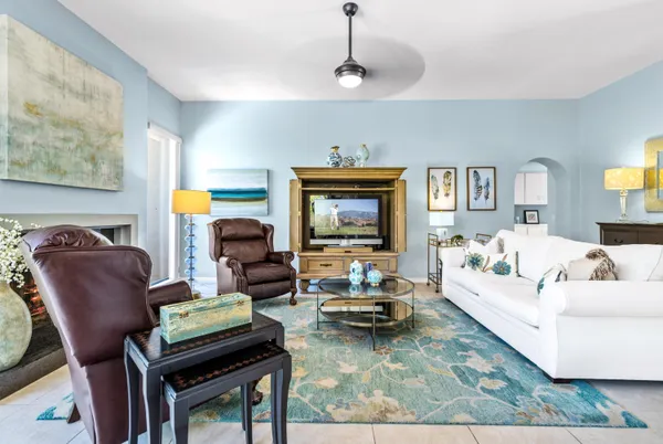a living room with furniture and a chandelier