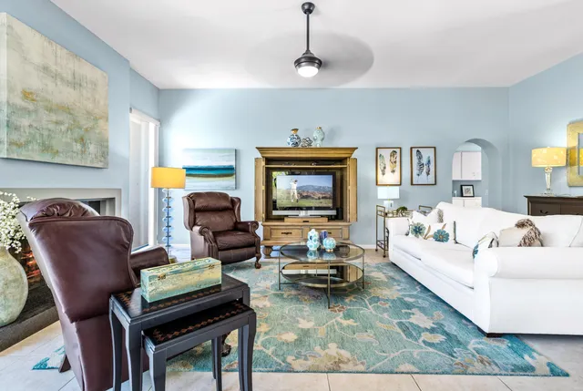 a living room with furniture and a chandelier