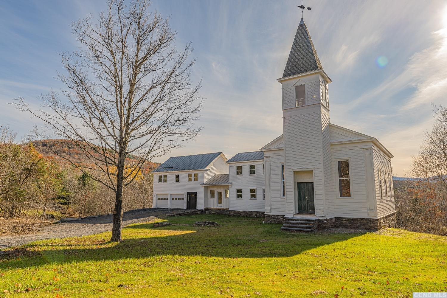 1174 Potter Mountain Road Gilboa, NY 12076 - Photo 6 of 94 a view of a large white house with a yard
