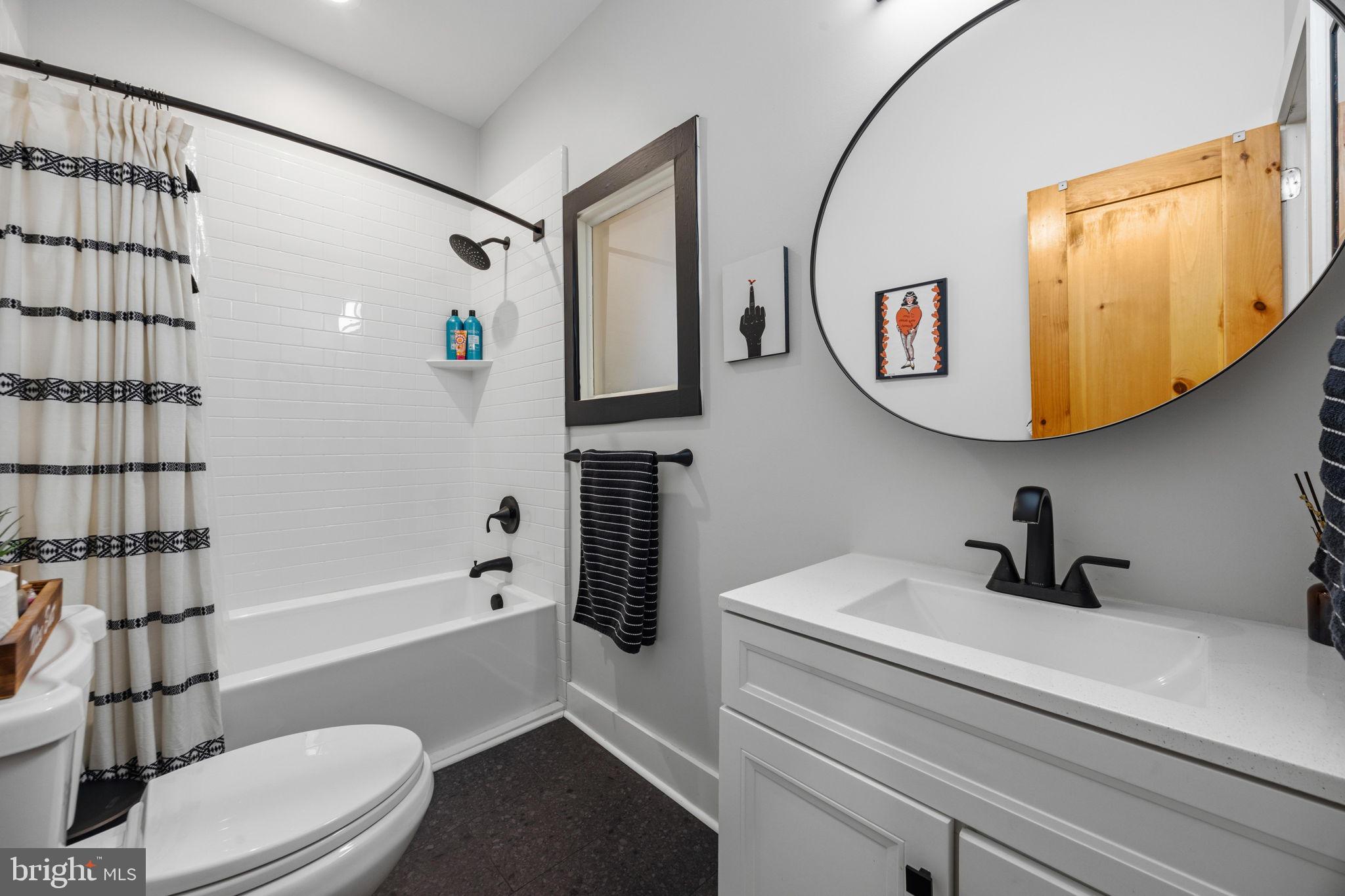 3208 Elliott Street Baltimore, MD 21224 - Photo 26 of 42 a bathroom with a sink a toilet and shower