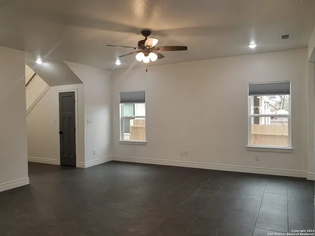 a view of a livingroom with a ceiling fan and window