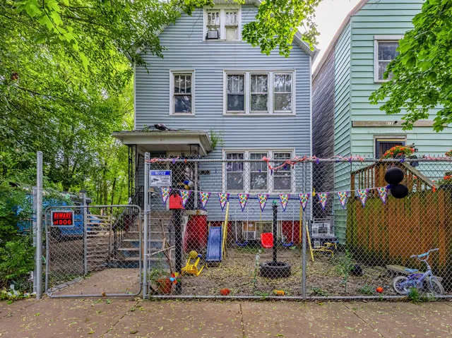 a view of a house with a patio and a car parked