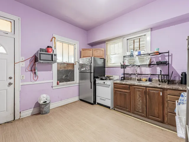 a kitchen with cabinets a sink and appliances