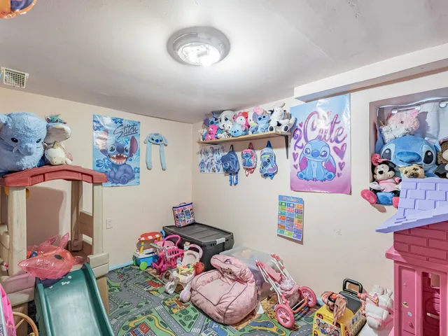 a bedroom with toys and a couch