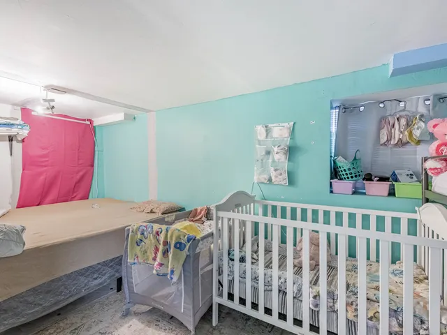 a bedroom with a bed and baby crib