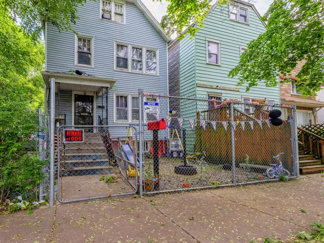 a view of a house with wooden fence
