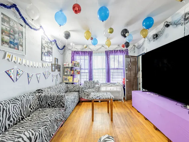 a living room with fireplace furniture and a flat screen tv