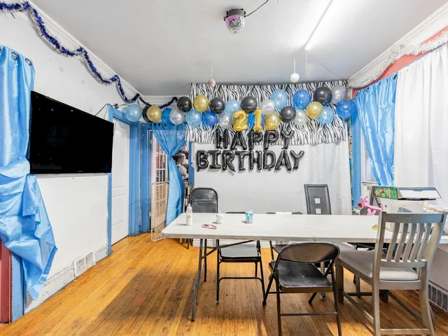 a view of a dining room with furniture and a flat screen tv
