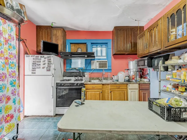 a kitchen with stainless steel appliances granite countertop a refrigerator stove top oven a sink and dishwasher