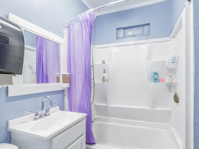 a bathroom with a bathtub a sink and a mirror