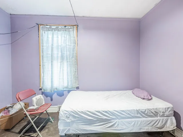 a bedroom with a bed and chair