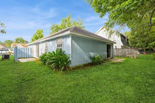a house that has a tree in front of it
