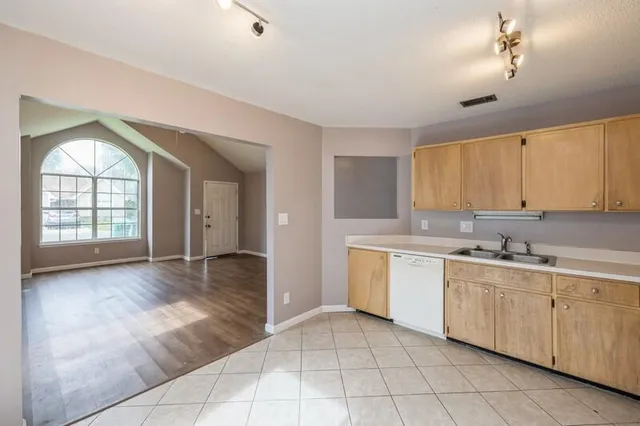 a large kitchen with a lot of cabinets and appliances