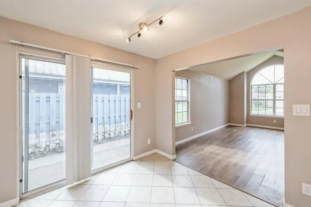 a view of an empty room with glass door