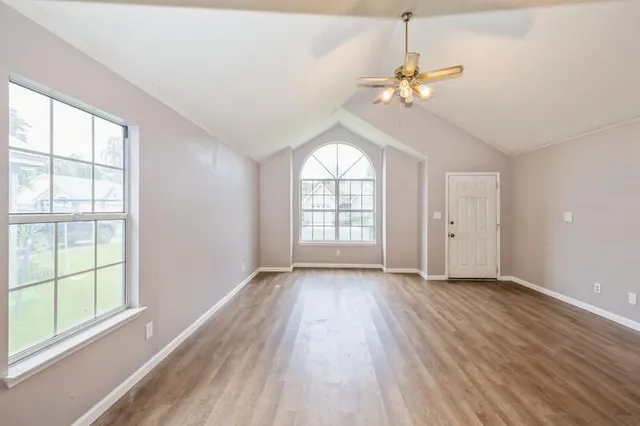 wooden floor in an empty room with a window