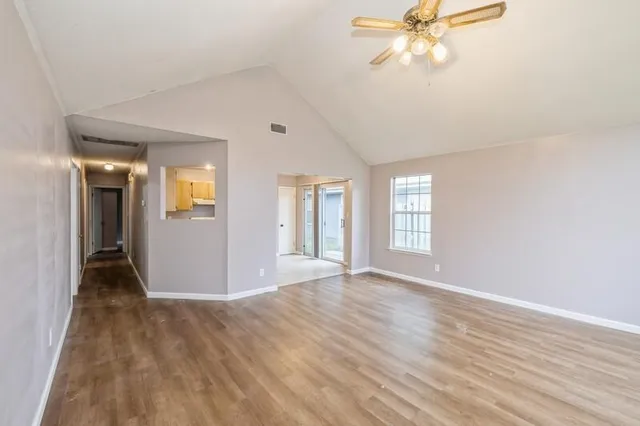 wooden floor in an empty room with a window