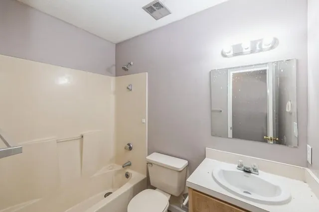 a bathroom with a sink toilet tub and shower