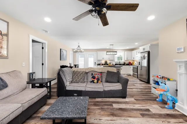 a living room with furniture and kitchen view