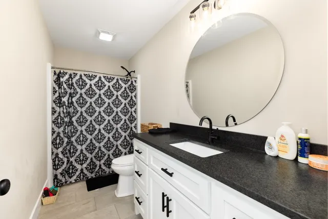 a kitchen with a sink and a mirror