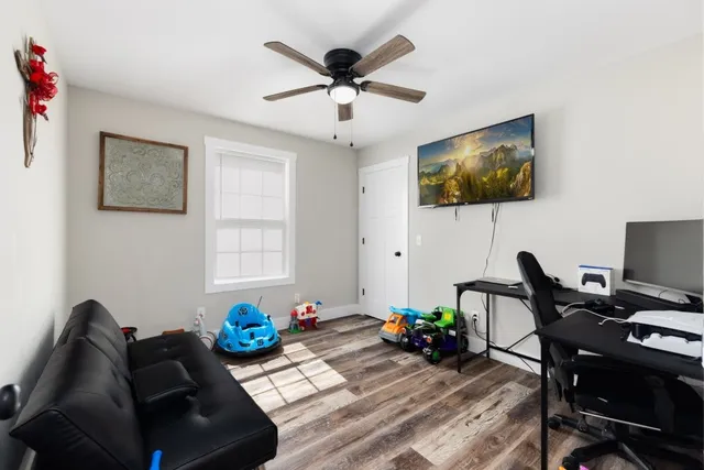 a view of a workspace with furniture and a window