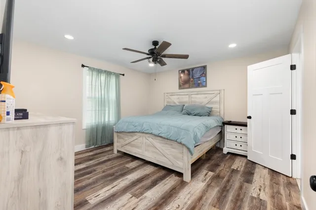 a bedroom with a bed and a ceiling fan