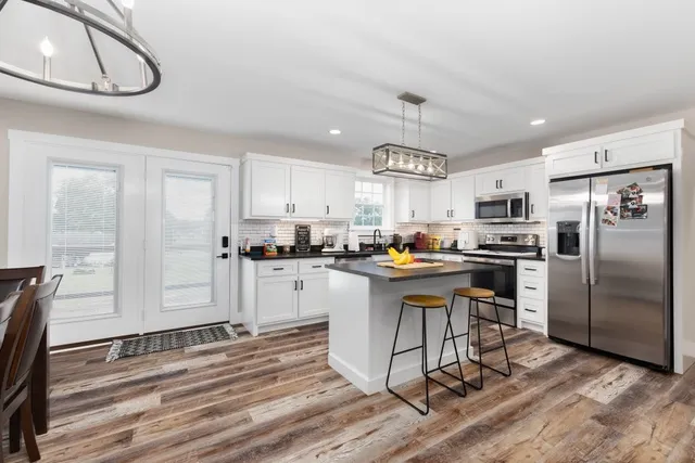 a kitchen with a refrigerator a sink and cabinets