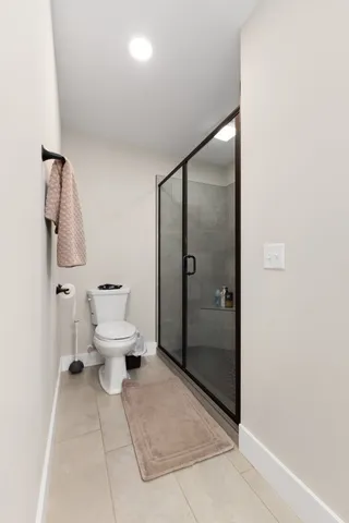 a bathroom with a toilet sink and shower