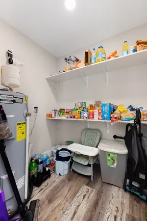 a utility room with toys and wooden floor