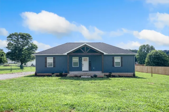 a front view of house with yard and green space