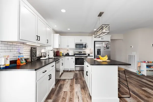 a kitchen with stainless steel appliances a refrigerator sink and cabinets
