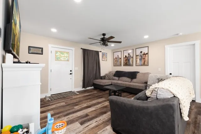 a living room with furniture and a ceiling fan