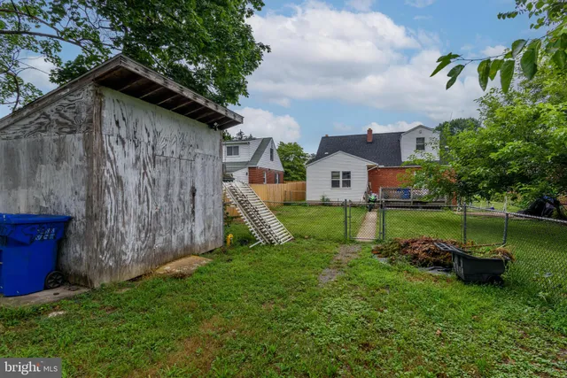 a view of a chair and table in backyard of the house