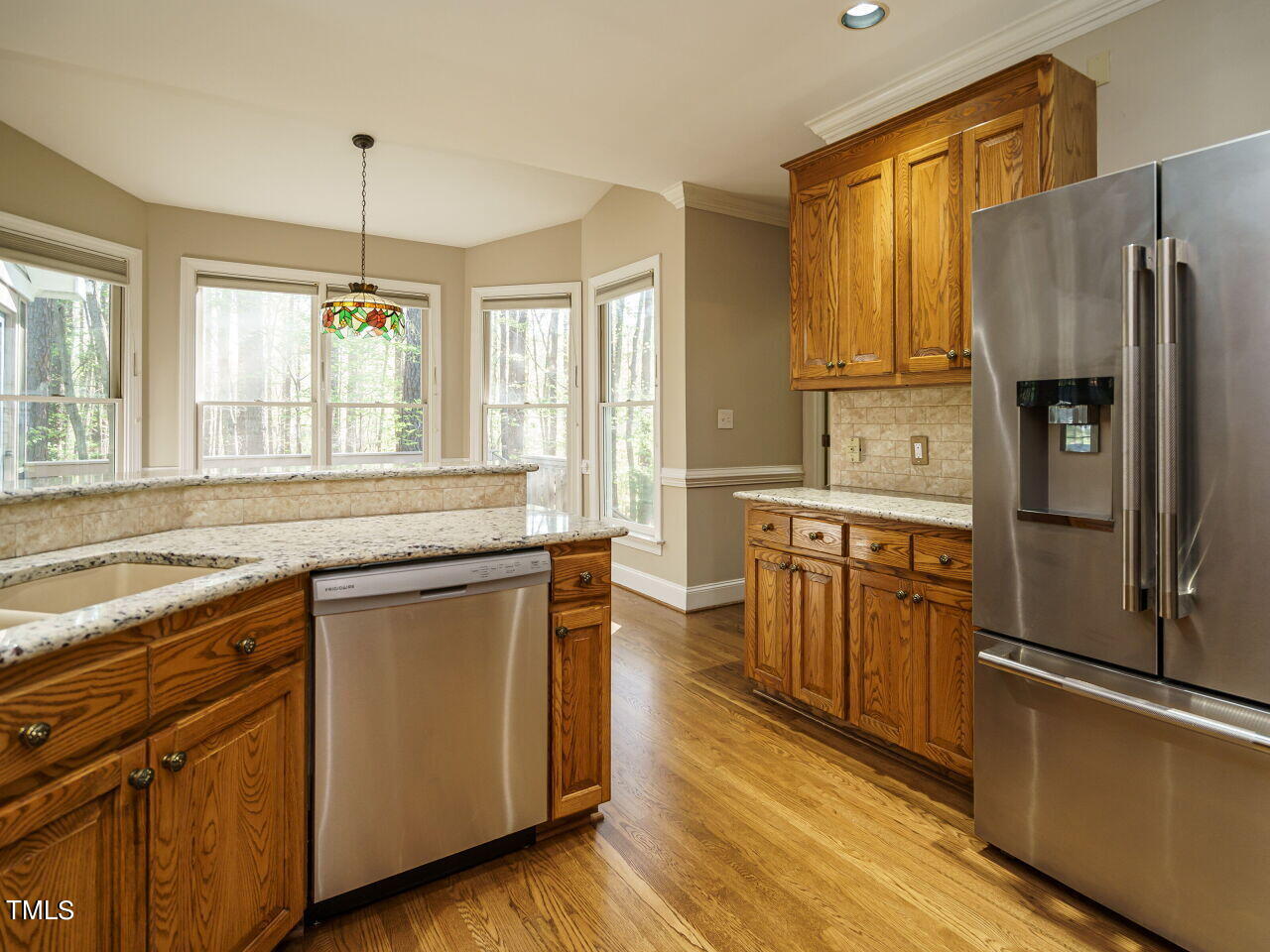 2320 Primrose Valley Court Raleigh, NC 27613 - Photo 12 of 43 a kitchen with stainless steel appliances granite countertop a refrigerator a sink dishwasher a stove and white countertops with wooden floor