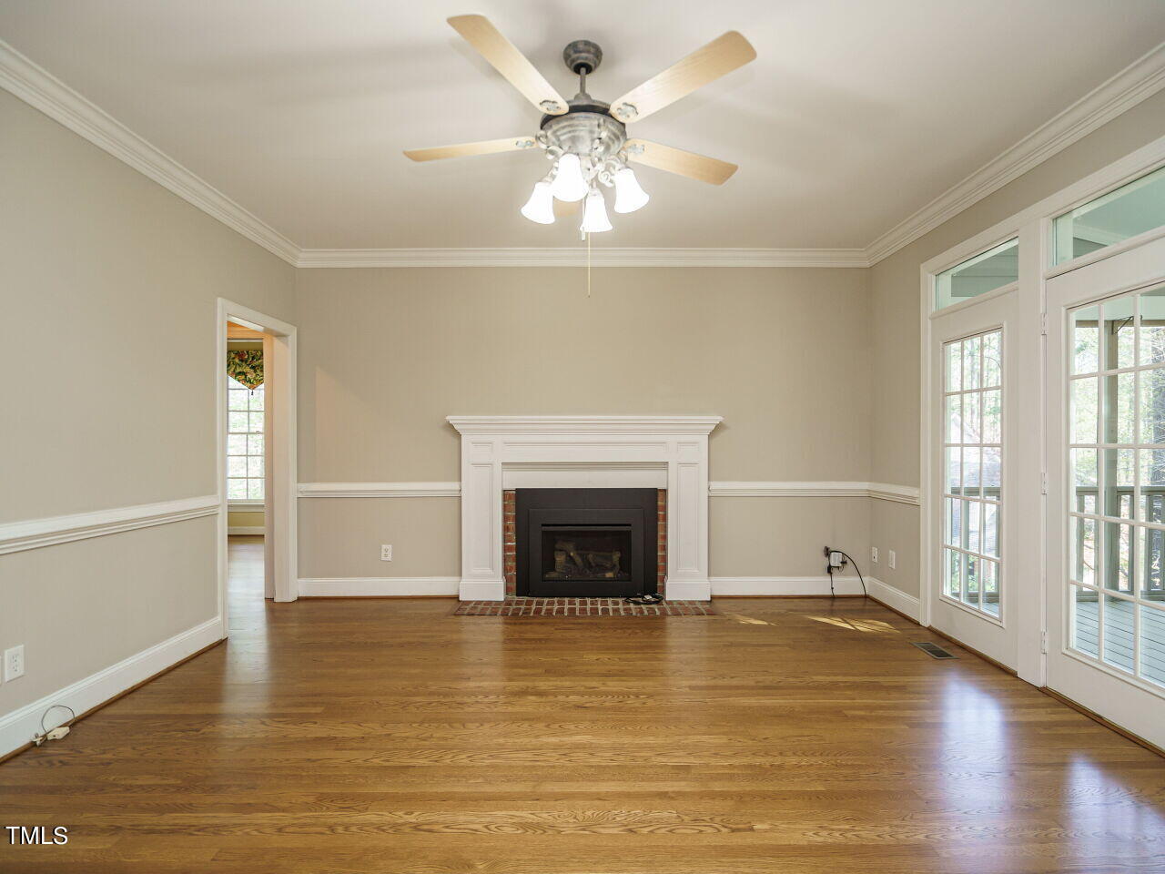 2320 Primrose Valley Court Raleigh, NC 27613 - Photo 17 of 43 wooden floor fireplace and windows in an empty room