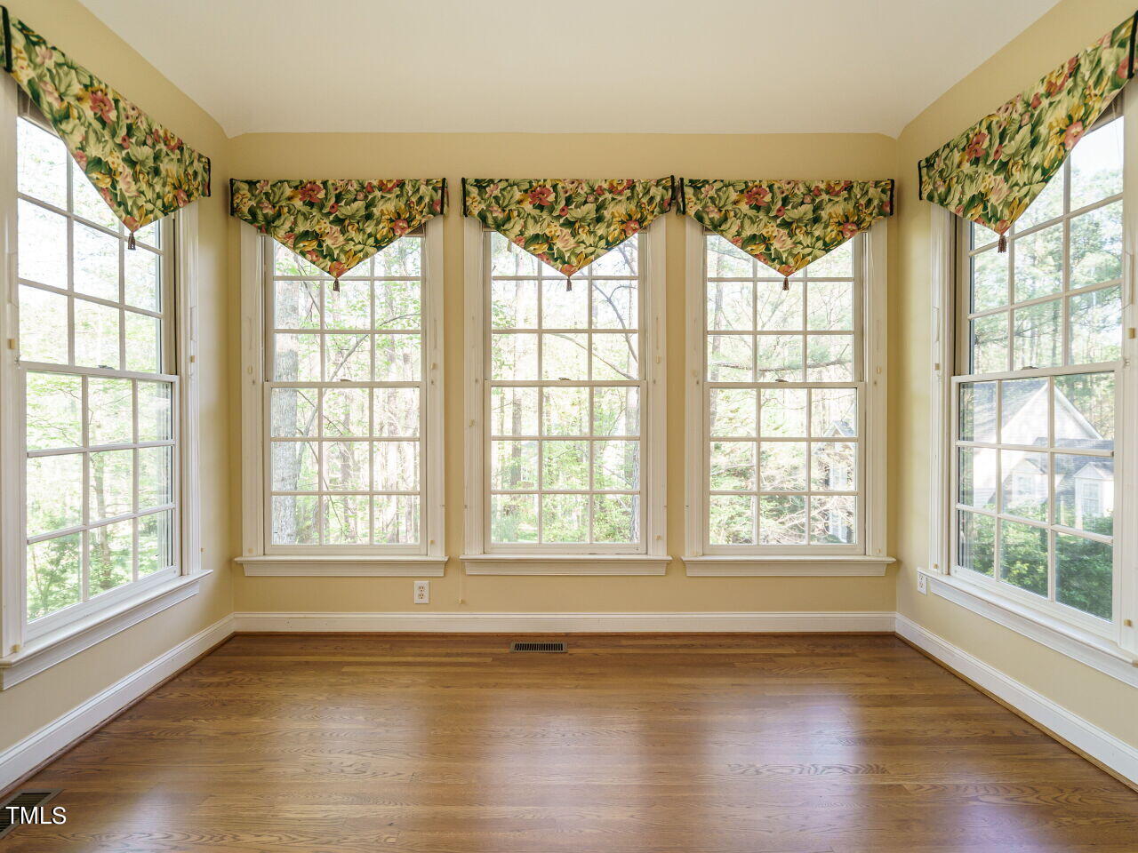 2320 Primrose Valley Court Raleigh, NC 27613 - Photo 22 of 43 a view of an empty room with wooden floor and a window