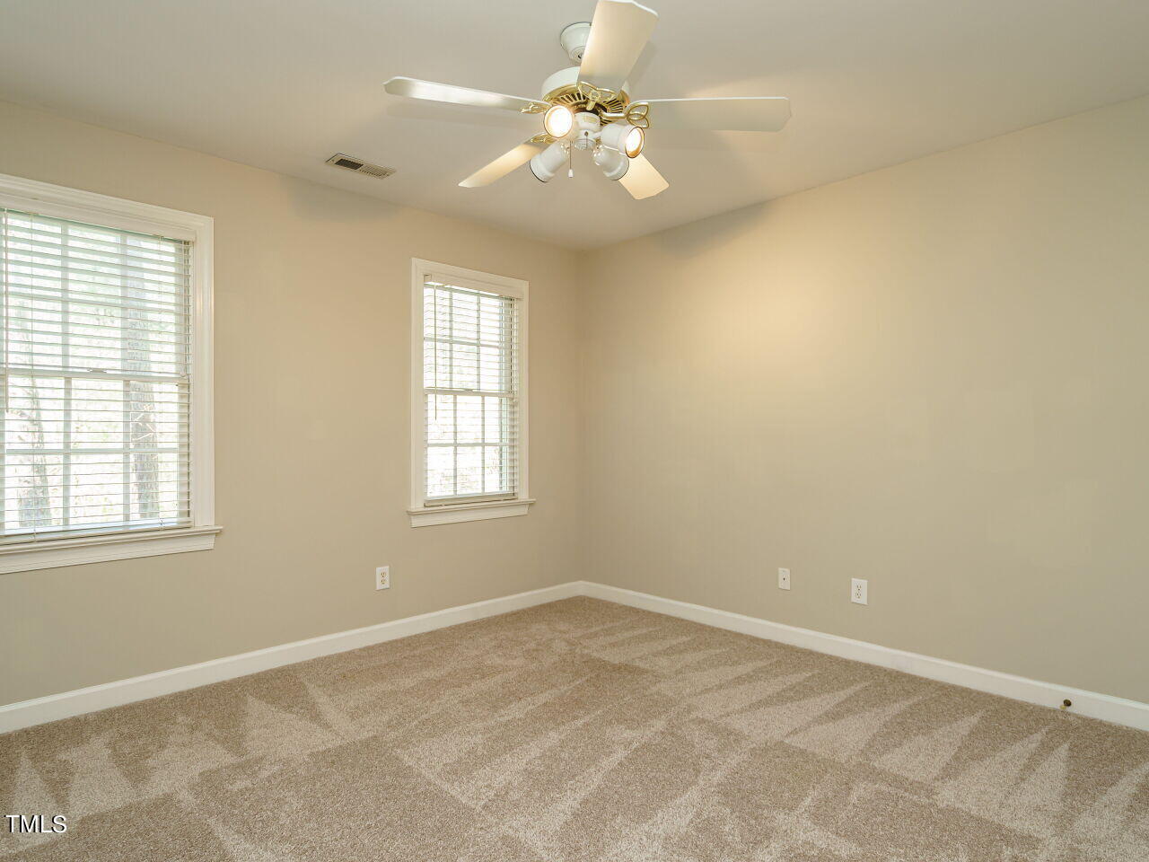 2320 Primrose Valley Court Raleigh, NC 27613 - Photo 32 of 43 an empty room with windows and chandelier fan