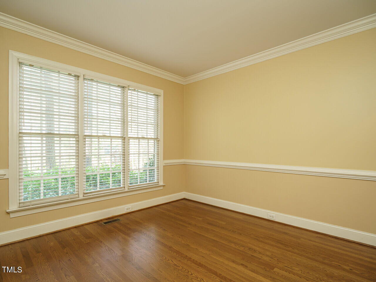 2320 Primrose Valley Court Raleigh, NC 27613 - Photo 5 of 43 a view of an empty room with wooden floor and a window