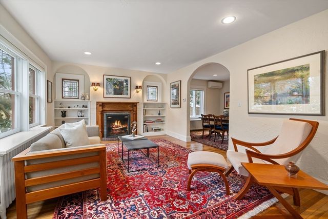 a living room with furniture a rug and a fireplace