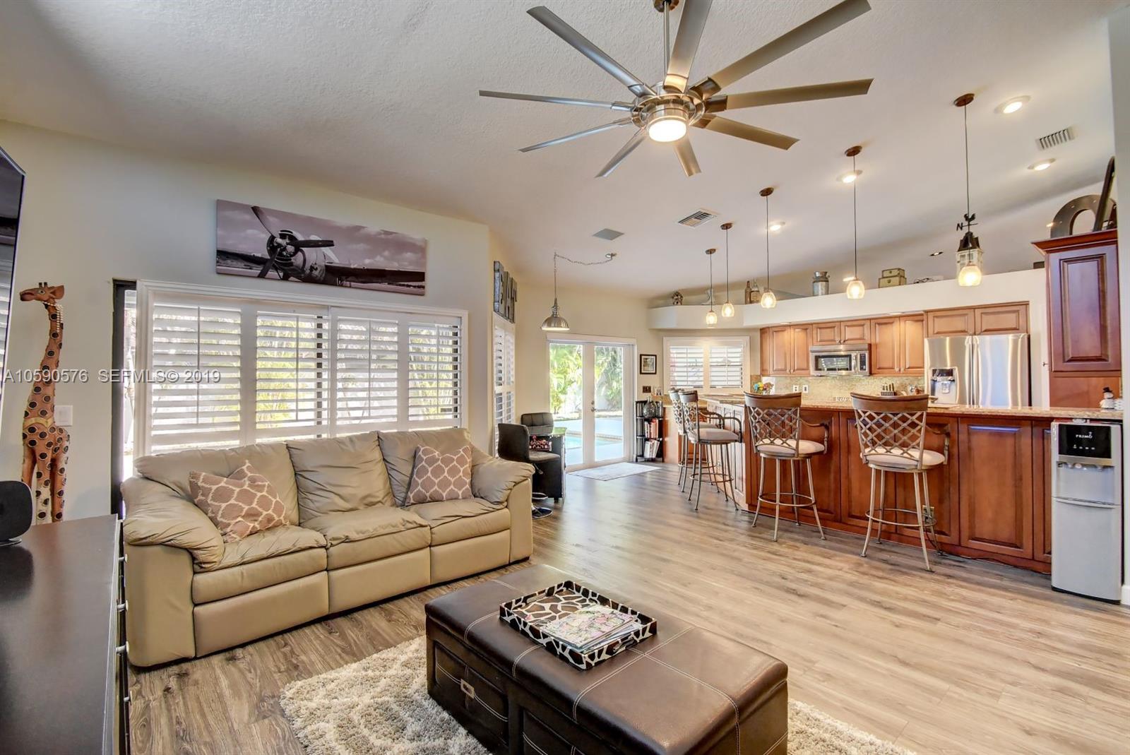 22324 Boyaca Avenue Boca Raton, FL 33433 - Photo 1 of 51 a living room with lots of furniture and a wooden floor