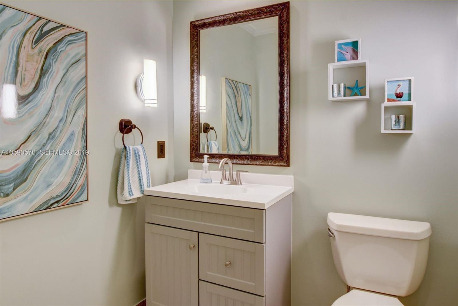 22324 Boyaca Avenue Boca Raton, FL 33433 - Photo 12 of 51 a bathroom with a toilet sink and mirror