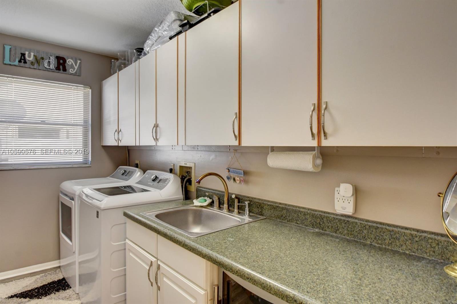 22324 Boyaca Avenue Boca Raton, FL 33433 - Photo 13 of 51 a kitchen with a sink and cabinets