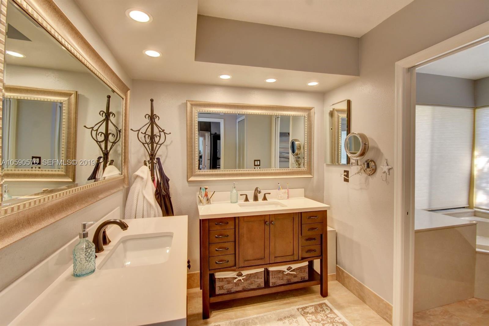 22324 Boyaca Avenue Boca Raton, FL 33433 - Photo 18 of 51 a bathroom with a double vanity sink and a mirror