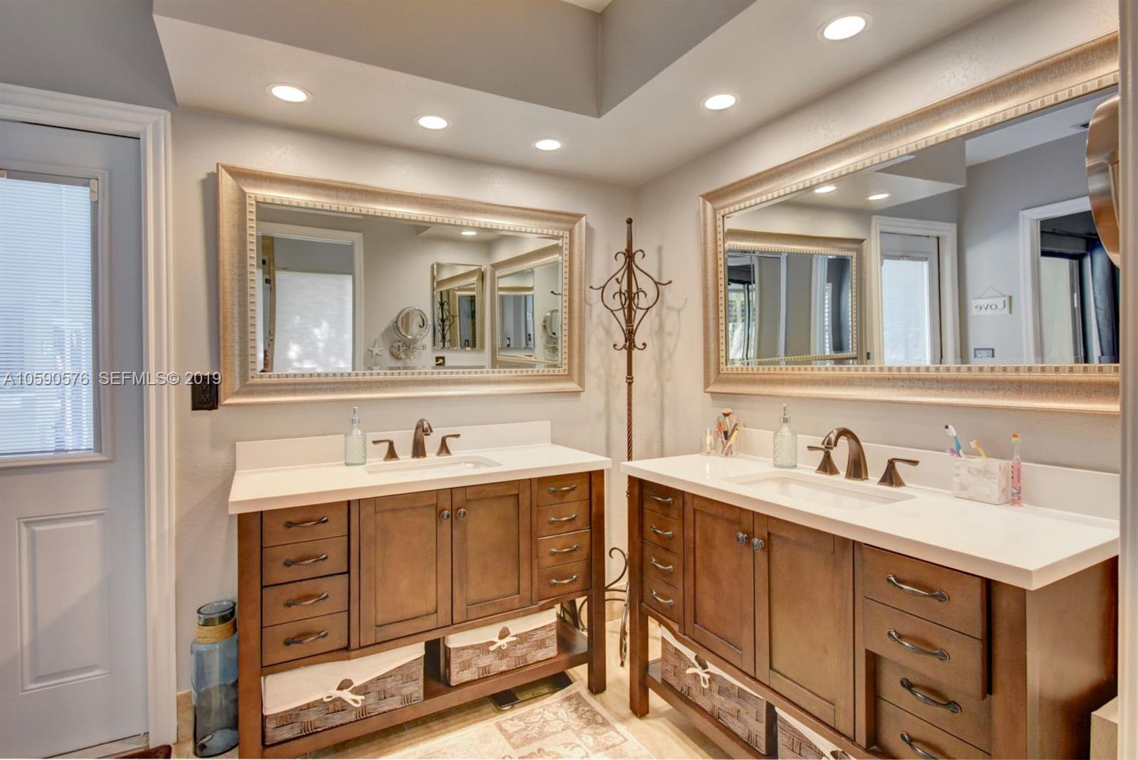 22324 Boyaca Avenue Boca Raton, FL 33433 - Photo 20 of 51 a bathroom with a sink and a mirror