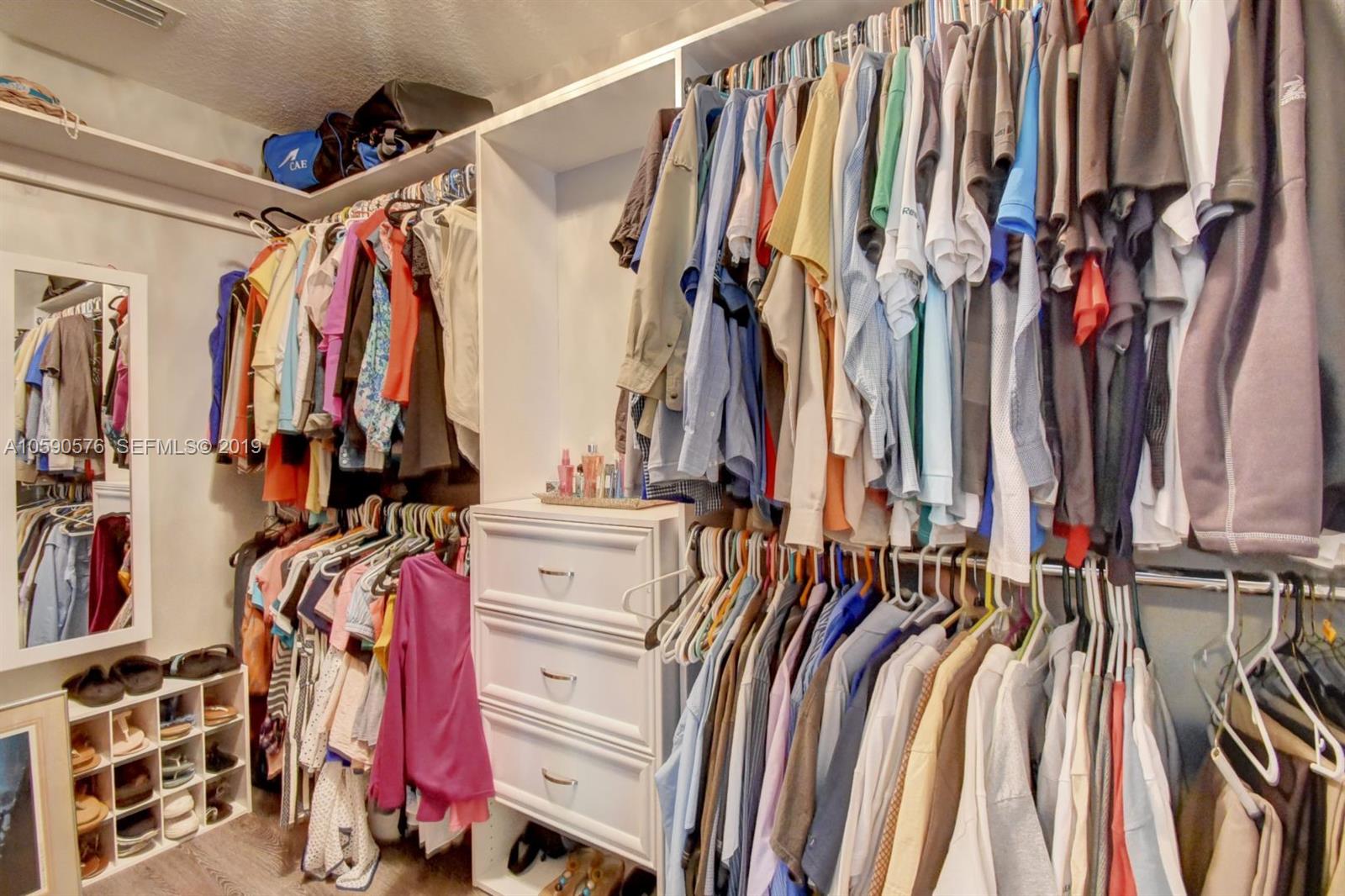 22324 Boyaca Avenue Boca Raton, FL 33433 - Photo 21 of 51 a view of walk in closet with clothes and shoes