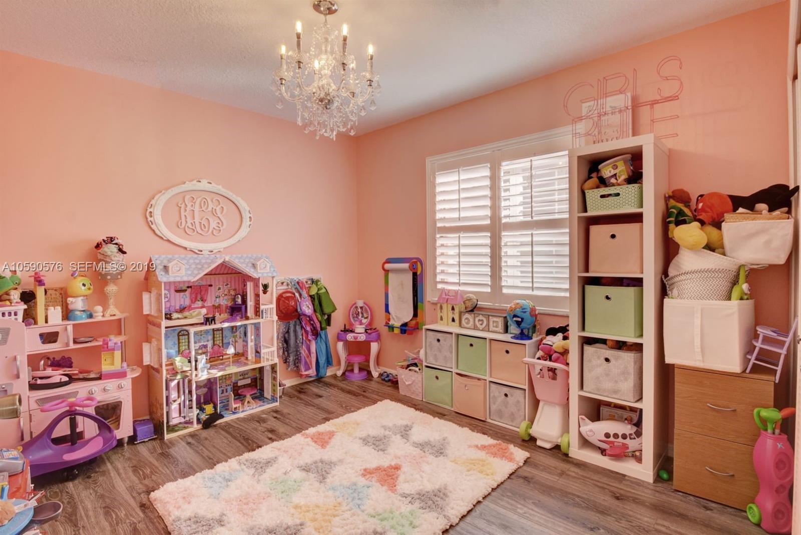 22324 Boyaca Avenue Boca Raton, FL 33433 - Photo 23 of 51 a living room with lots of furniture and chandelier