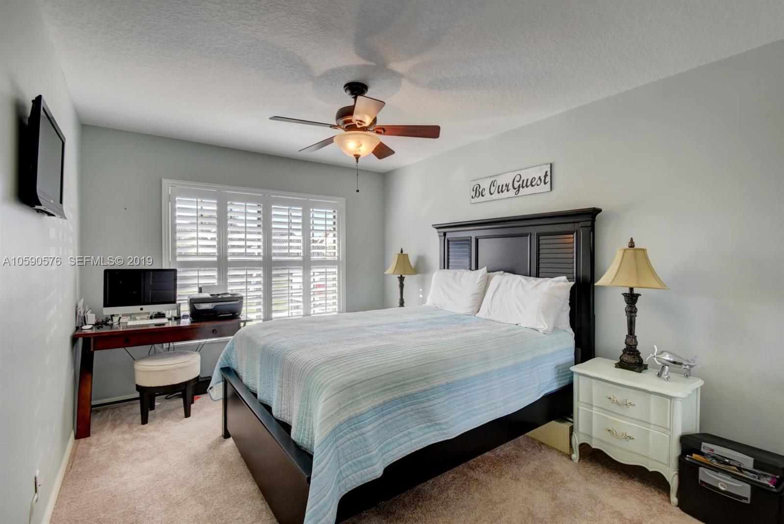 22324 Boyaca Avenue Boca Raton, FL 33433 - Photo 24 of 51 a bedroom with a bed and a chandelier