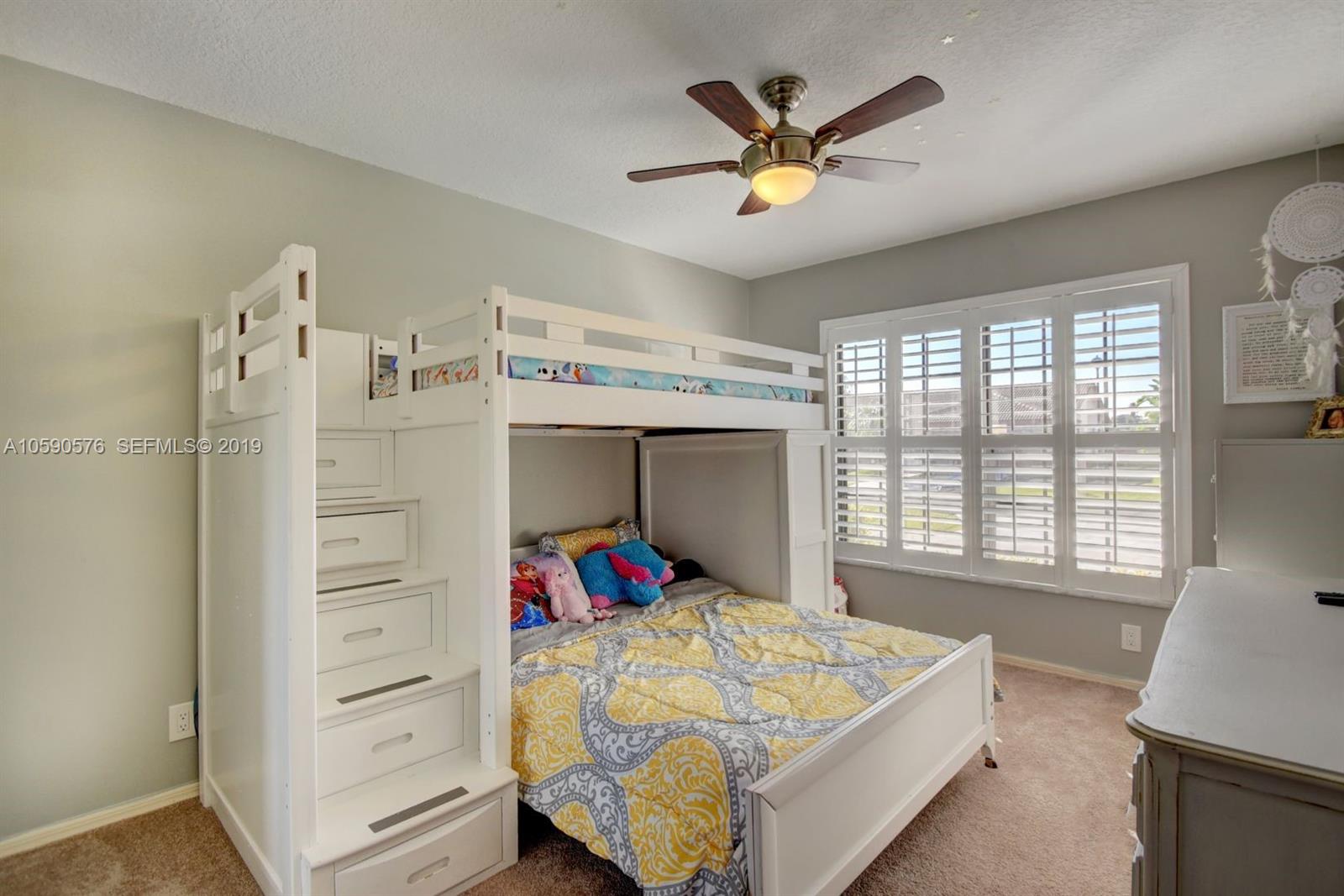 22324 Boyaca Avenue Boca Raton, FL 33433 - Photo 25 of 51 a bed room with a bed and a window