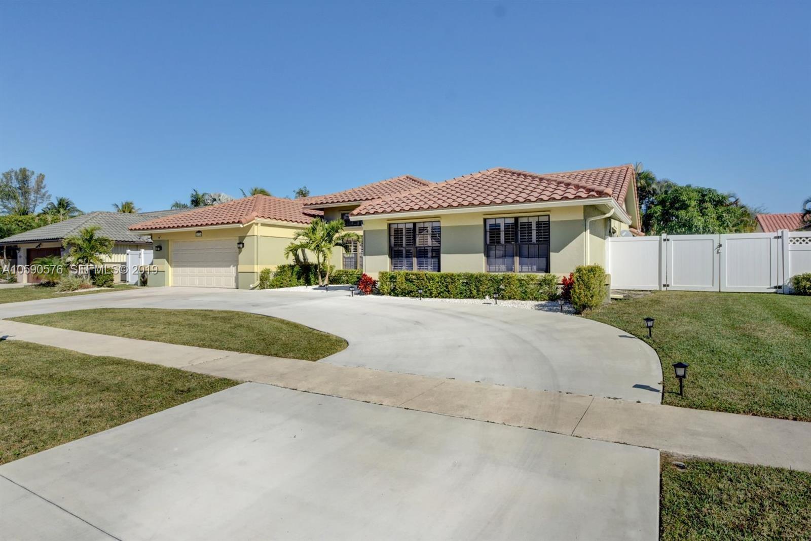 22324 Boyaca Avenue Boca Raton, FL 33433 - Photo 27 of 51 a front view of a house with a yard